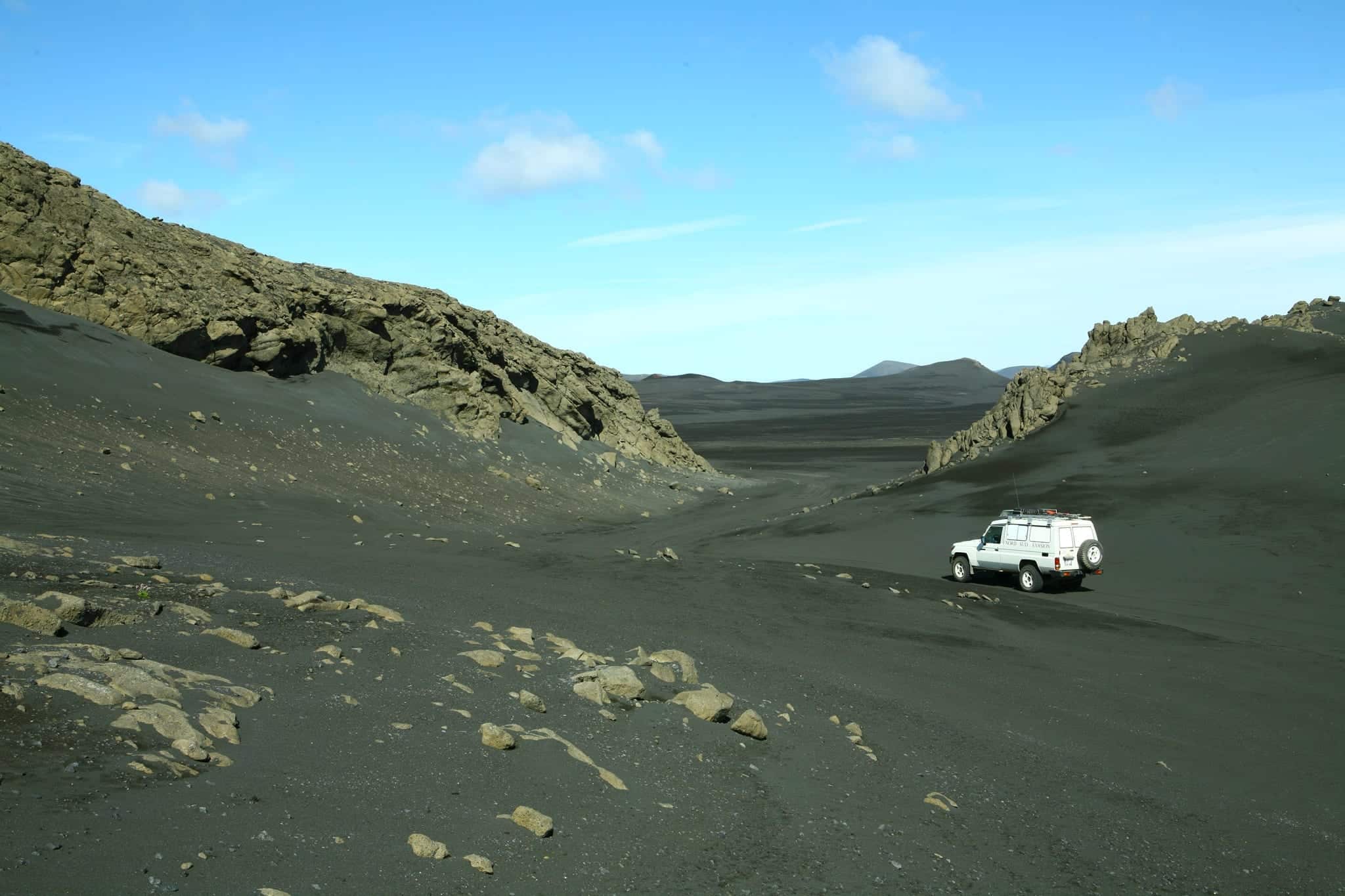 4x4 blanc dans un superbe défilé rocheux dans le sable noir pendant le raid 4x4 hekla Islande, juillet 2020